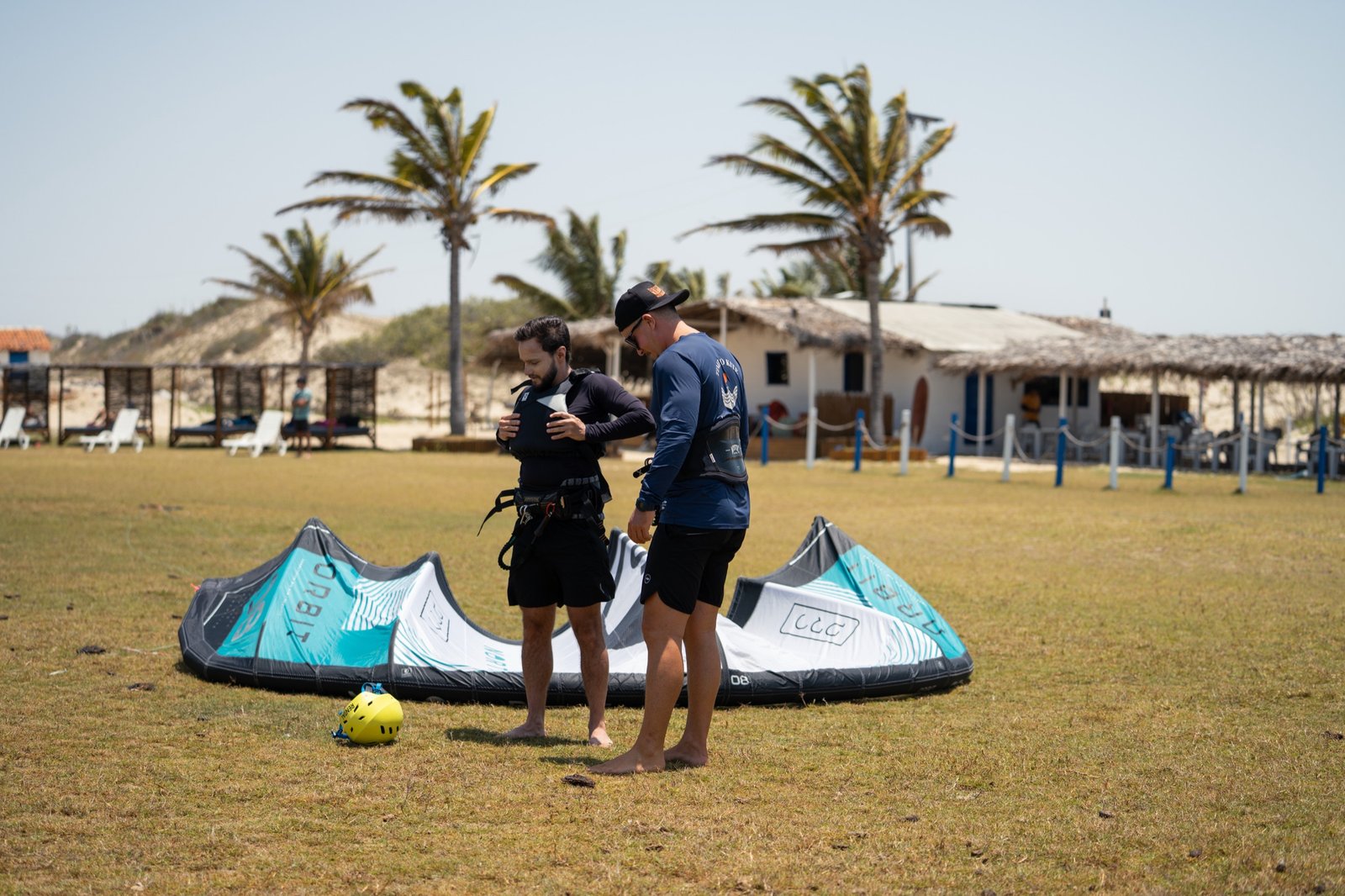 Instructor briefing a student over the kite during ground school on the lawn