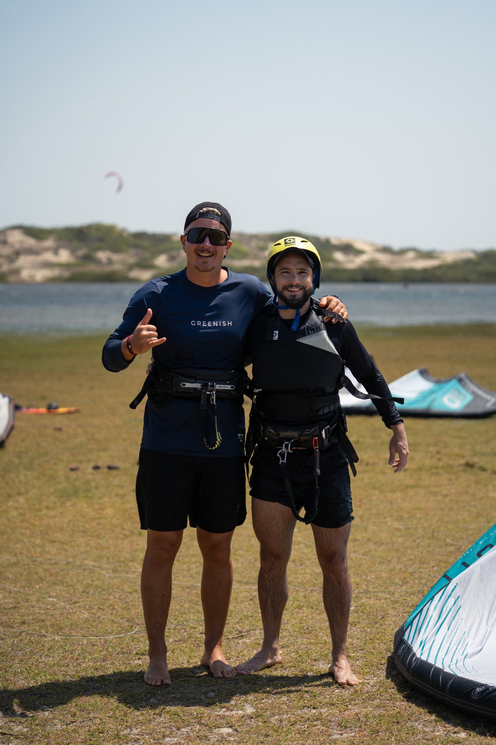 Instructor and student on the beach after a session, thumbs up