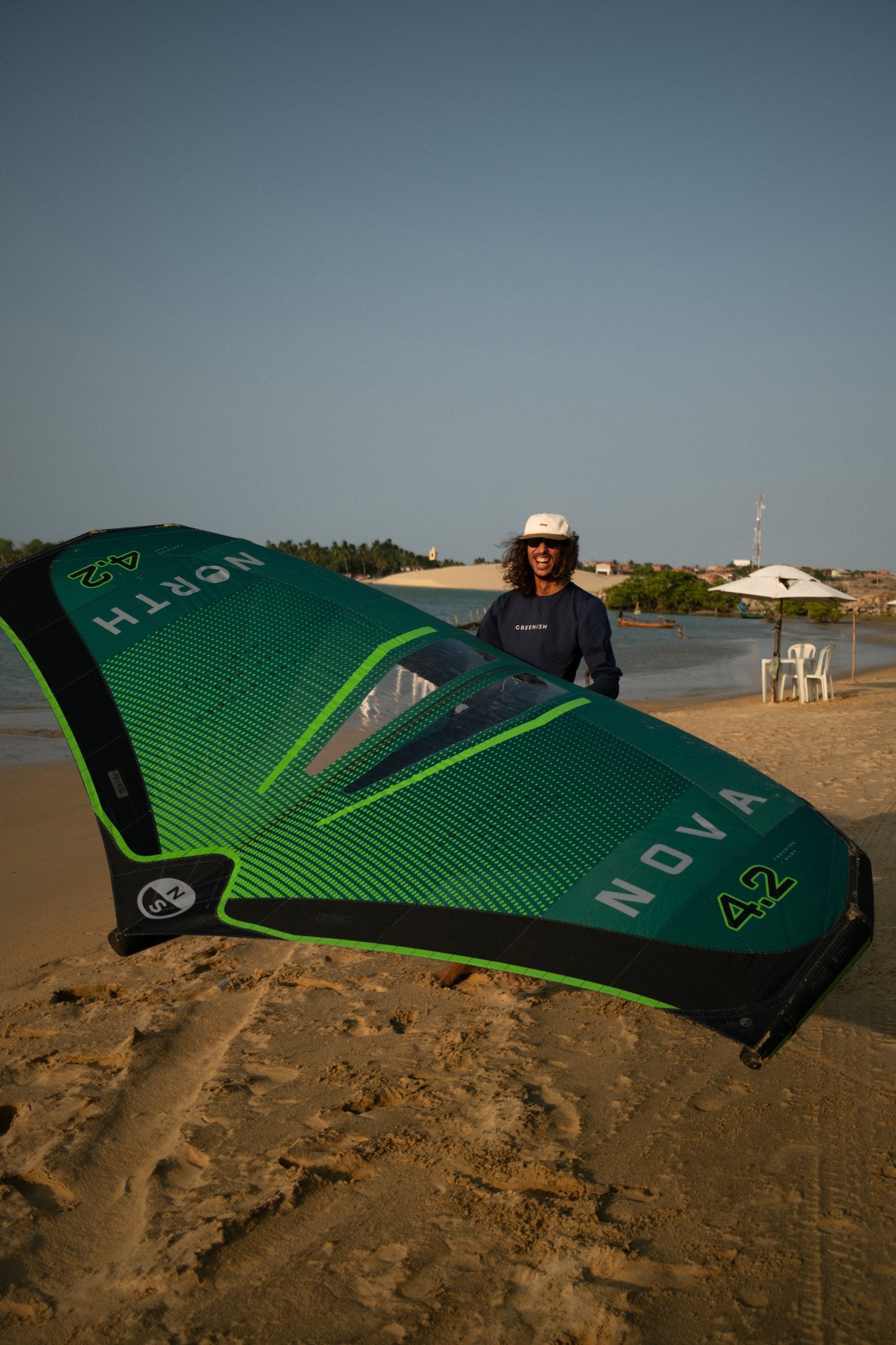 Rider holding a North wing on the shoreline of the Mundau lagoon