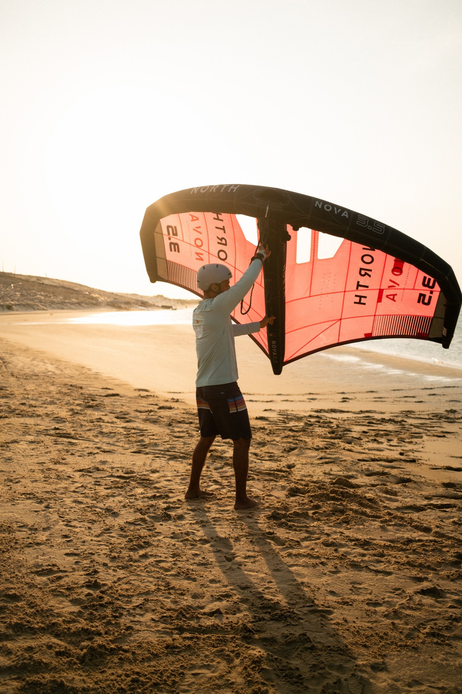 Rider handling the wing alone in golden light, ready to ride free